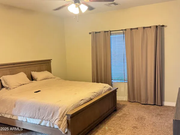 a bed sitting in a bedroom next to a bathroom