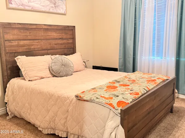 a bedroom with a bed and a window