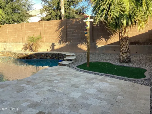 a view of a balcony with chair and wooden floor