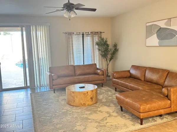 a living room with furniture and a potted plant