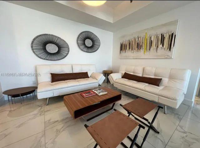 a view of a room with furniture and window