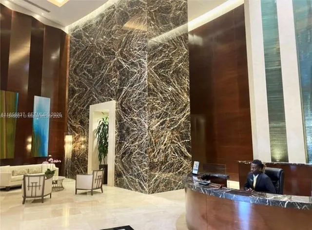 a living room with a couch and a chandelier