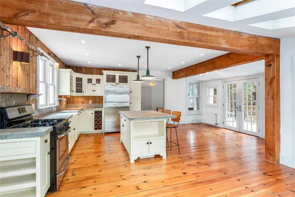 a kitchen with stainless steel appliances granite countertop a stove and a wooden floors