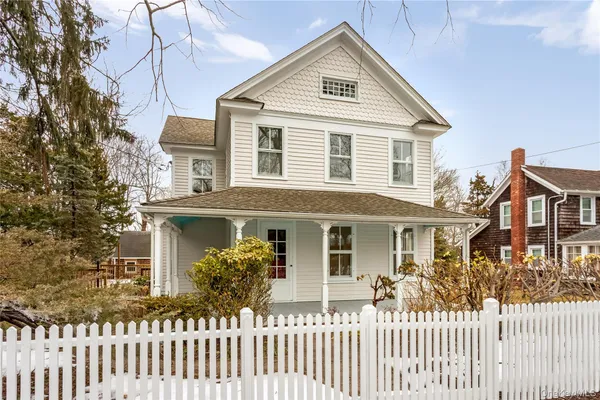 a front view of a house with wooden fence