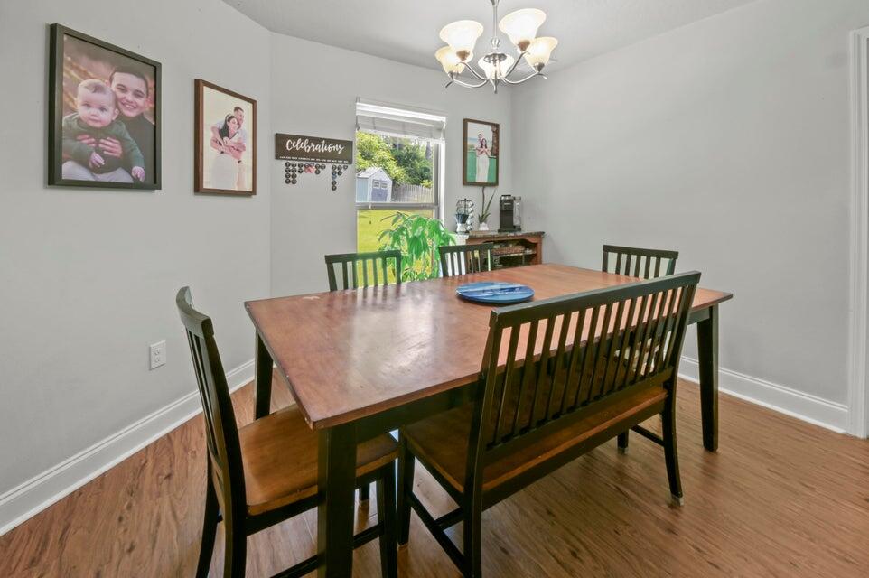 300 Cassady Lane Crestview, FL 32539 - Photo 12 of 25 a view of a dining room with furniture a chandelier and wooden floor