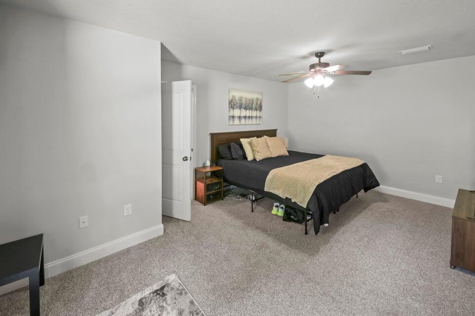 300 Cassady Lane Crestview, FL 32539 - Photo 13 of 25 a bedroom with a bed and a chandelier