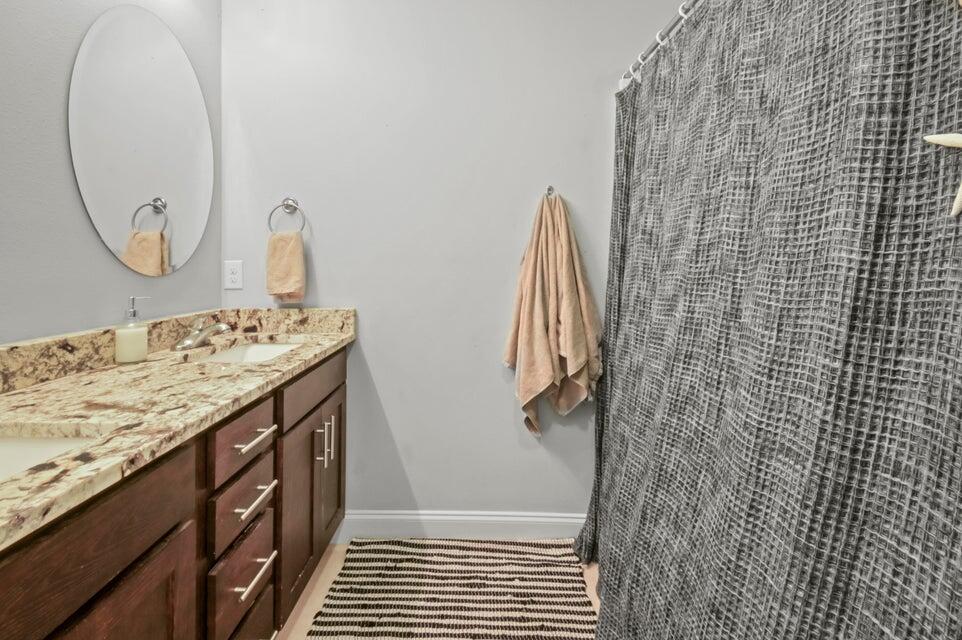 300 Cassady Lane Crestview, FL 32539 - Photo 15 of 25 a bathroom with a granite countertop sink a shower and a mirror