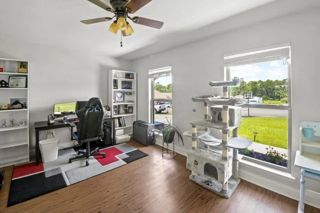 a view of a workspace with furniture and a window