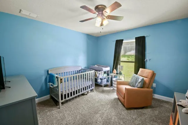 a bedroom with furniture and a window