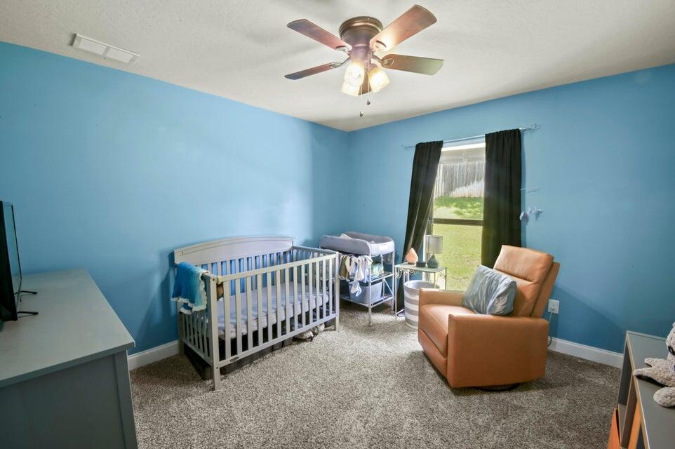 300 Cassady Lane Crestview, FL 32539 - Photo 21 of 25 a bedroom with furniture and a window
