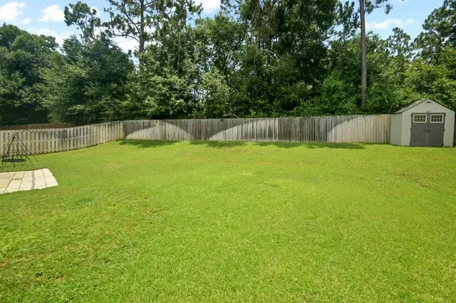 a backyard of a house with trees and plants