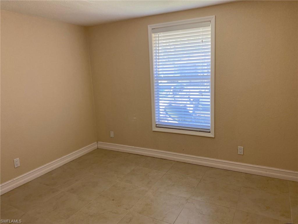 5389 Treetops Drive Naples, FL 34113 - Photo 5 of 8 Spare room featuring baseboards