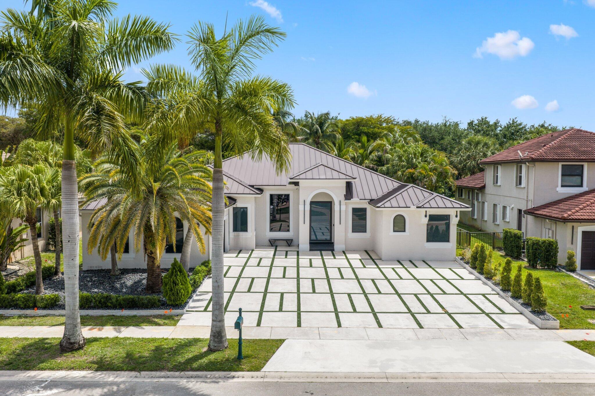 4265 Southwest 185th Avenue Miramar, FL 33029 - Photo 2 of 64 a front view of a house with a yard