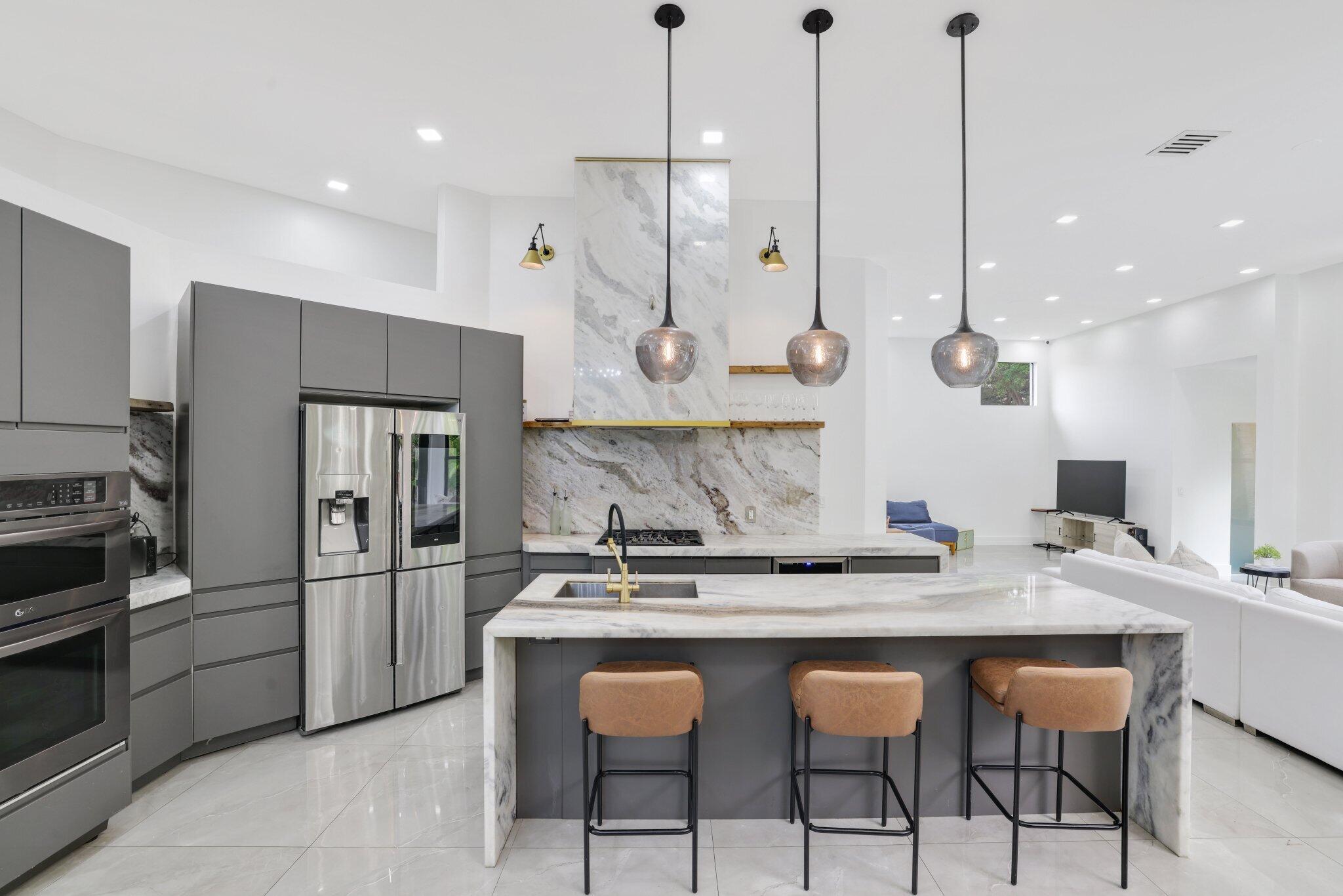4265 Southwest 185th Avenue Miramar, FL 33029 - Photo 22 of 64 a kitchen with a refrigerator a sink and chairs