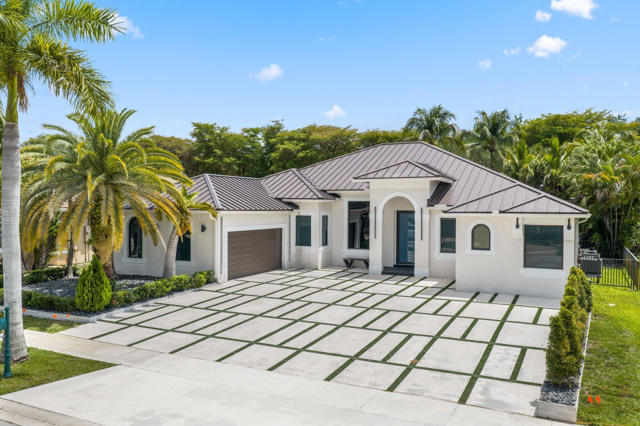 4265 Southwest 185th Avenue Miramar, FL 33029 - Photo 3 of 64 a front view of a house with a yard