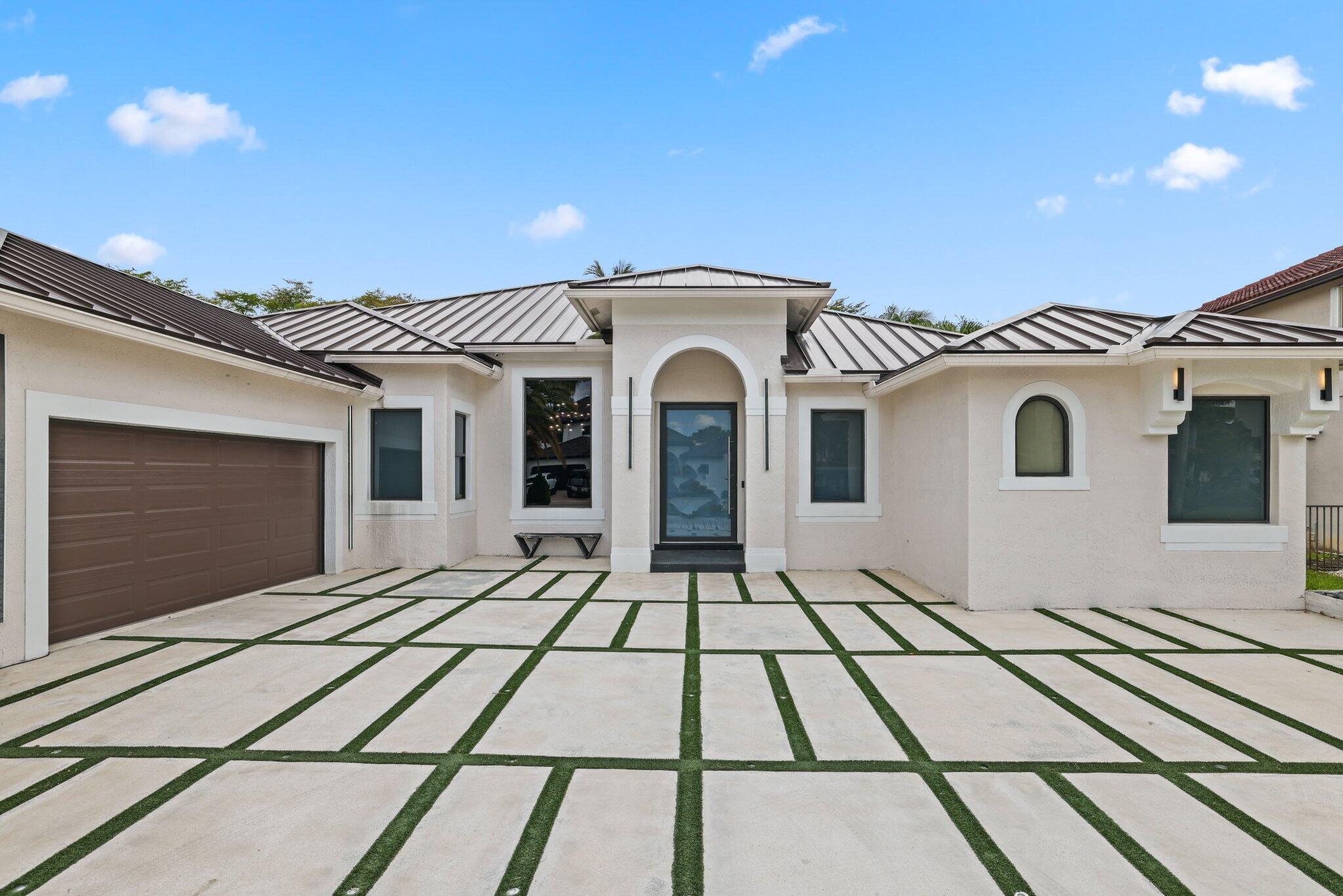 4265 Southwest 185th Avenue Miramar, FL 33029 - Photo 4 of 64 a view of a white house with a large window
