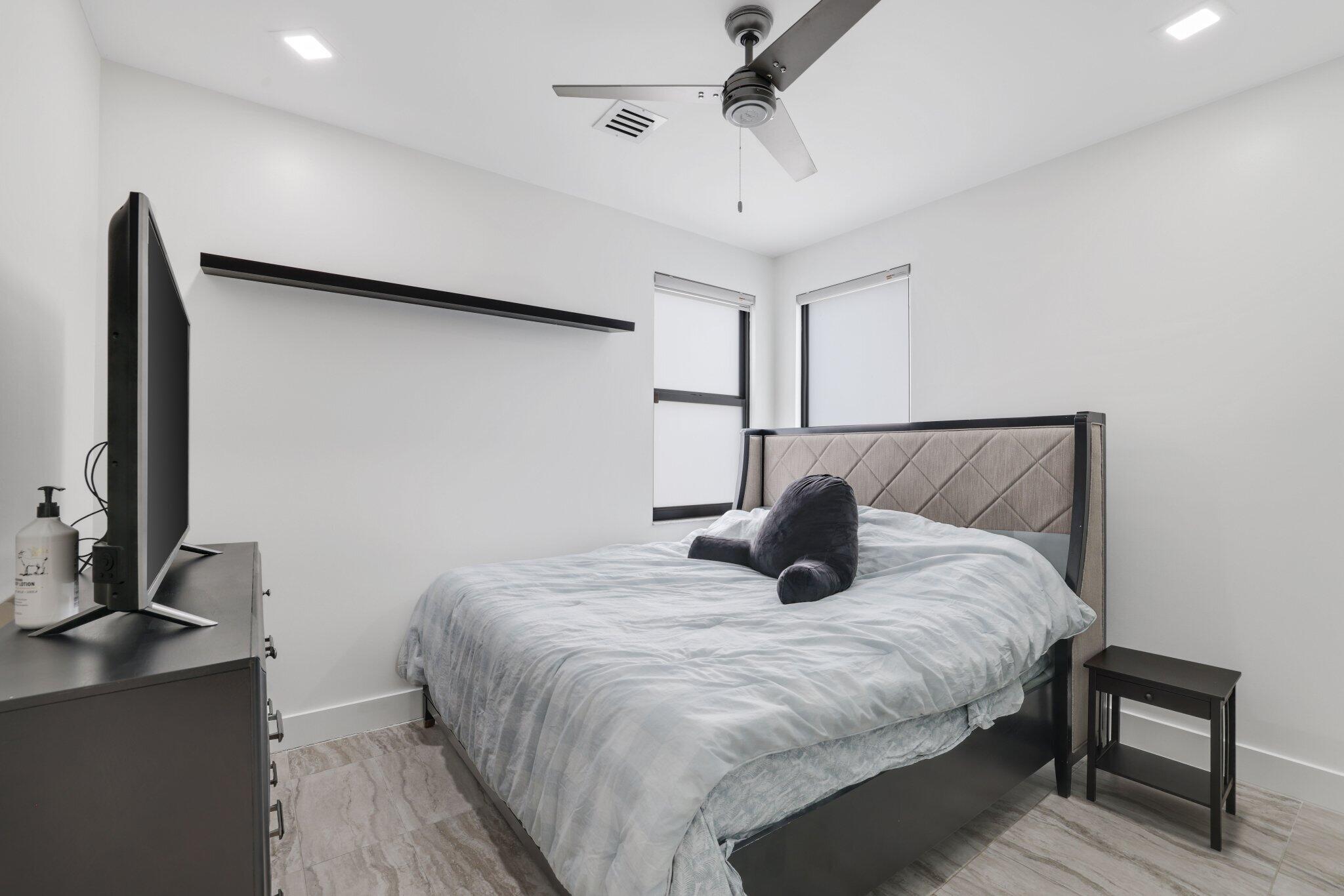 4265 Southwest 185th Avenue Miramar, FL 33029 - Photo 44 of 64 a bedroom with a bed and a flat screen tv