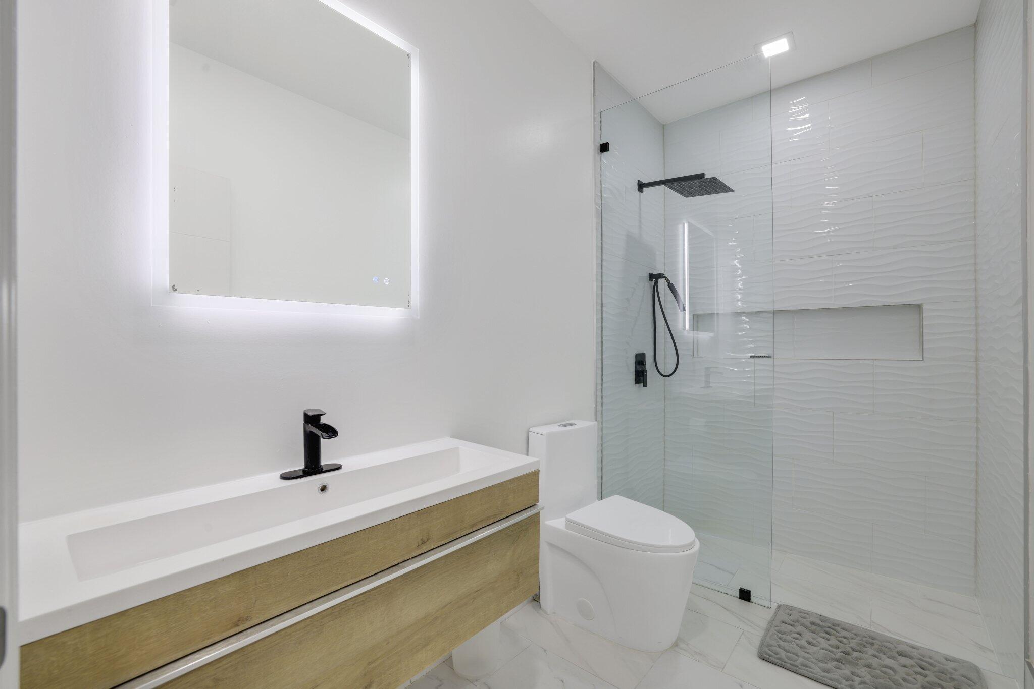 4265 Southwest 185th Avenue Miramar, FL 33029 - Photo 45 of 64 a bathroom with a toilet a sink and shower