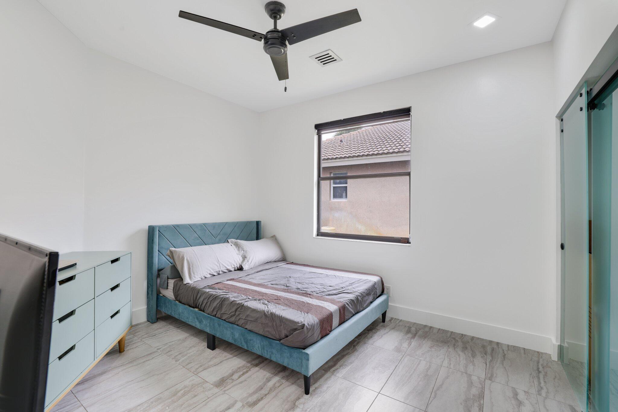 4265 Southwest 185th Avenue Miramar, FL 33029 - Photo 46 of 64 a bedroom with a bed and a night stand
