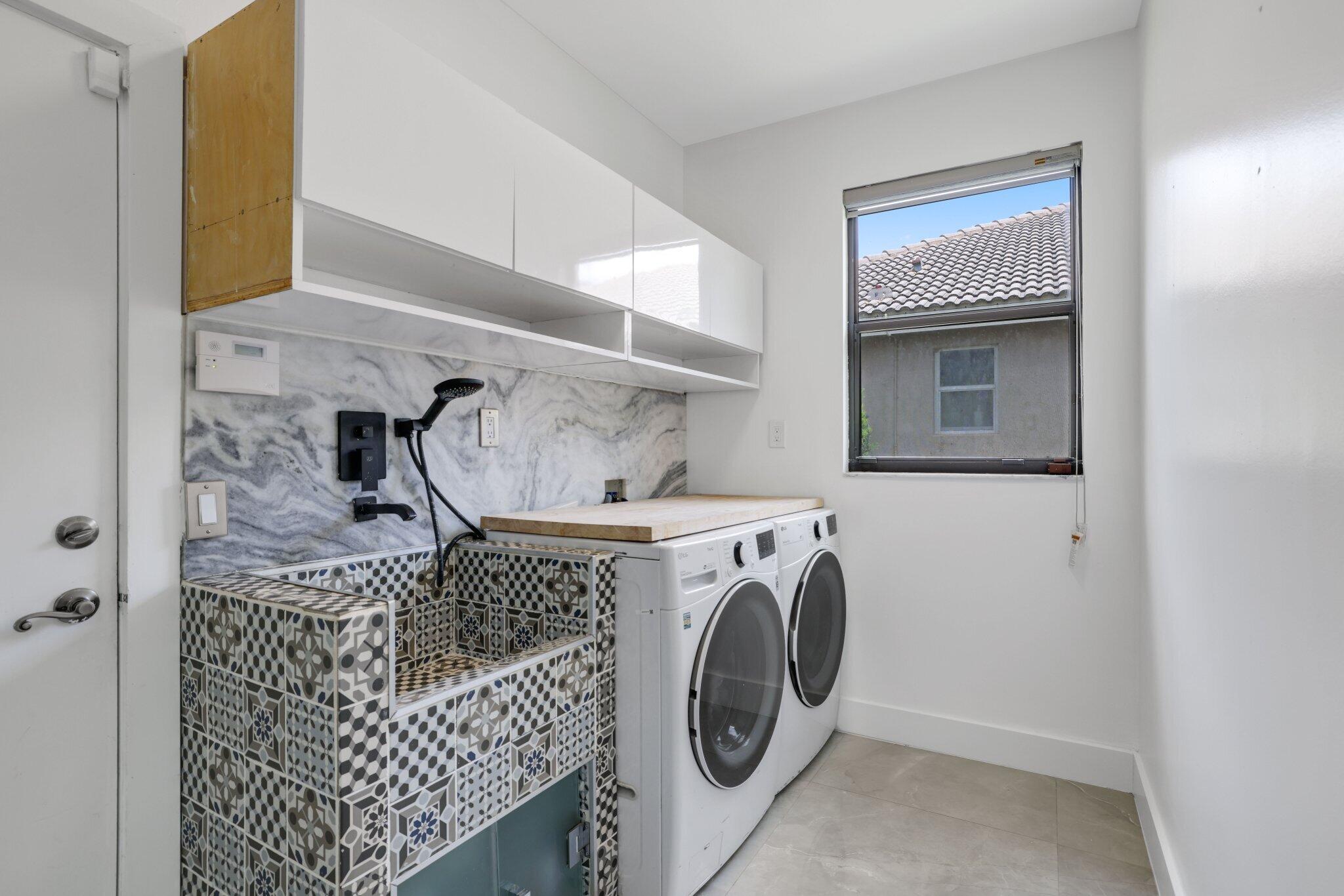4265 Southwest 185th Avenue Miramar, FL 33029 - Photo 50 of 64 a utility room with dryer and washer