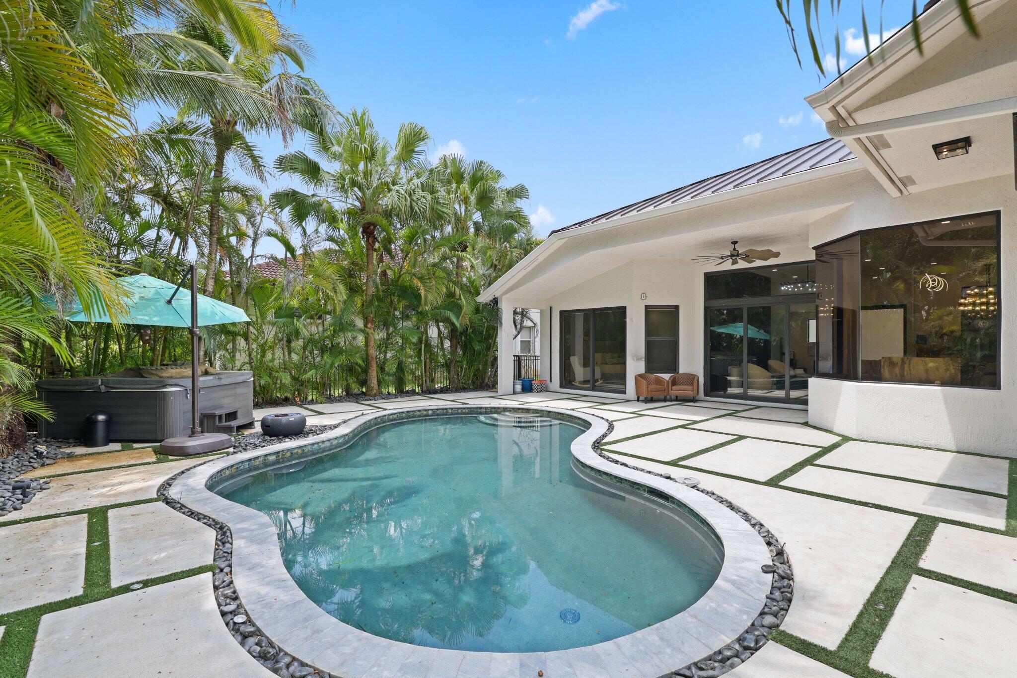 4265 Southwest 185th Avenue Miramar, FL 33029 - Photo 53 of 64 a view of a house with swimming pool and sitting area