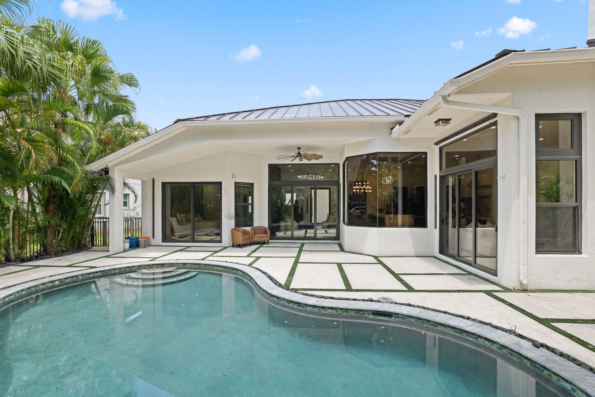4265 Southwest 185th Avenue Miramar, FL 33029 - Photo 54 of 64 a view of a white house with swimming pool in front of it