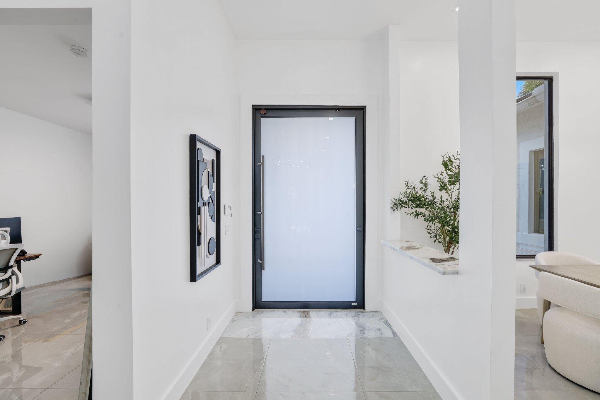 4265 Southwest 185th Avenue Miramar, FL 33029 - Photo 7 of 64 a view of a hallway with wooden floor and a potted plant