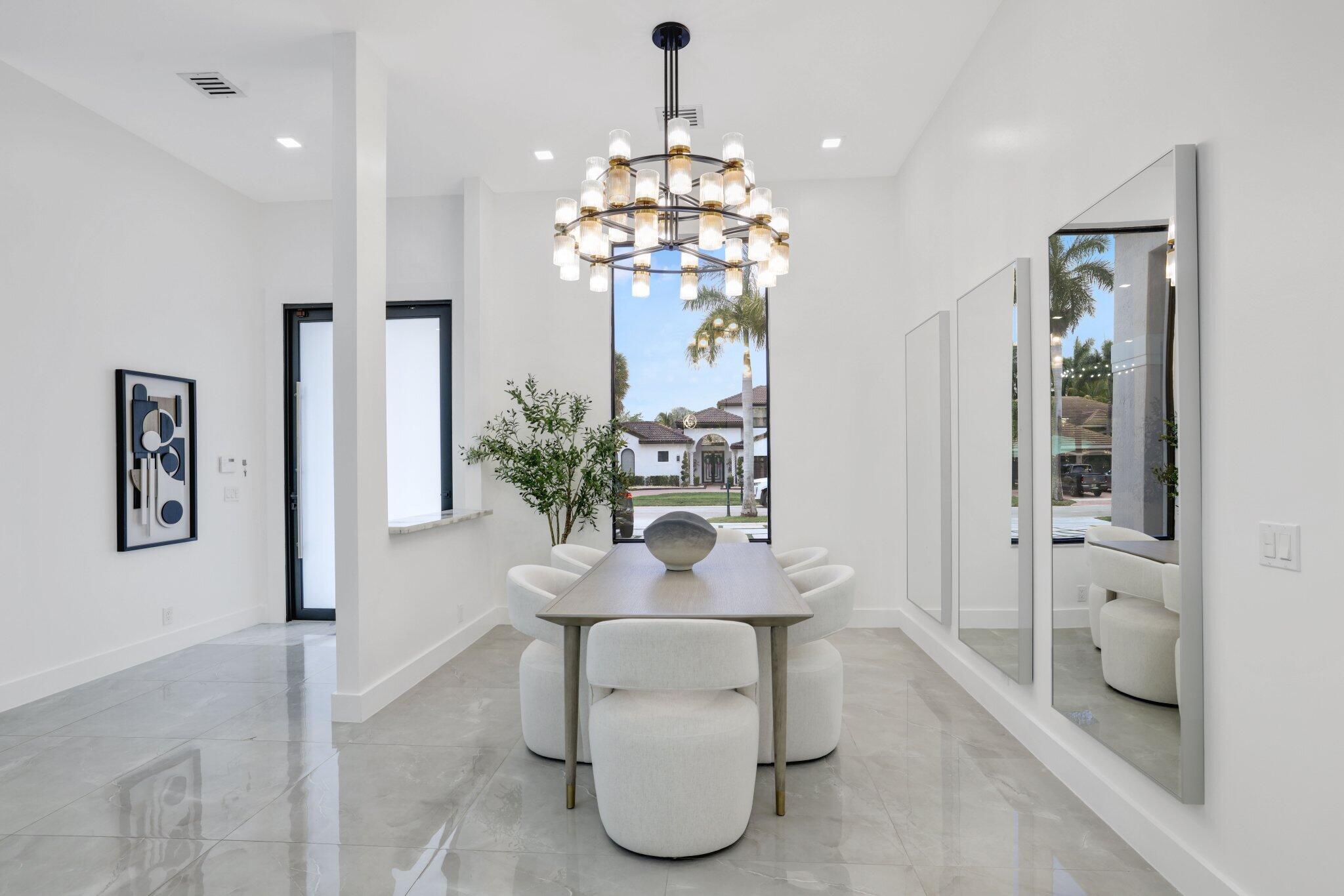 4265 Southwest 185th Avenue Miramar, FL 33029 - Photo 10 of 64 a dining room with chandelier and wooden floor