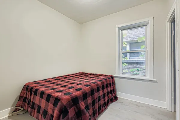 a bedroom with a bed and a window