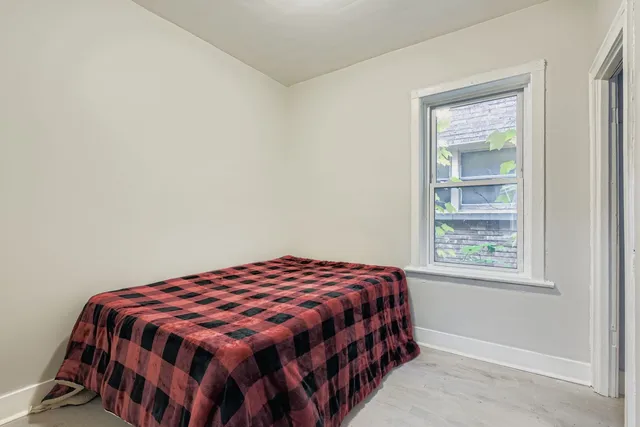 a bedroom with a bed and a window