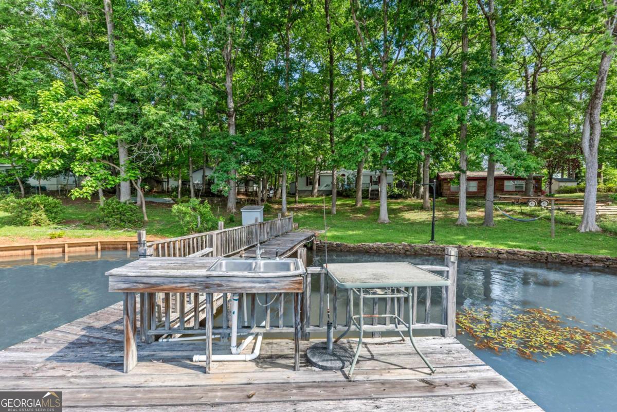 194 Phillips Road Eatonton, GA 31024 - Photo 8 of 57 a view of house with backyard outdoor seating and lake