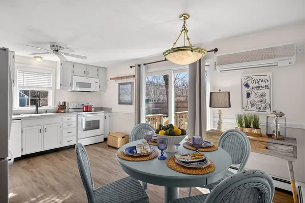 a dining room with furniture a chandelier and wooden floor