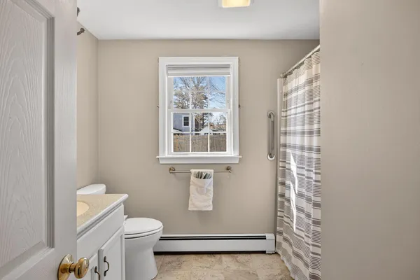 a bathroom with a sink a toilet and shower