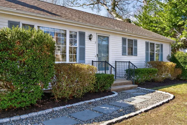 a front view of a house with garden