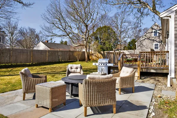a view of a house with backyard and sitting area