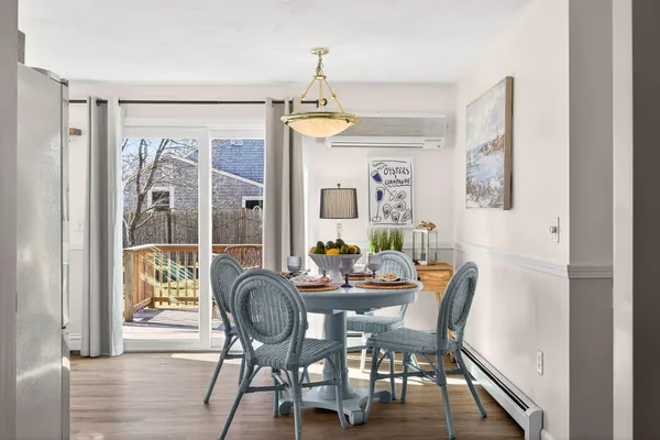 a dining room with furniture and wooden floor