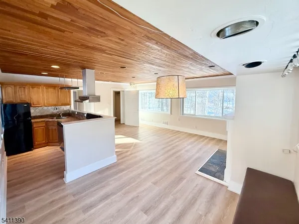 a large kitchen with cabinets and wooden floor