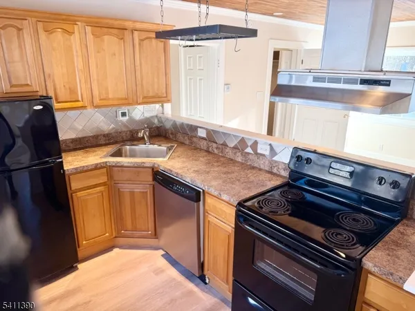 a kitchen with a stove a sink and a microwave