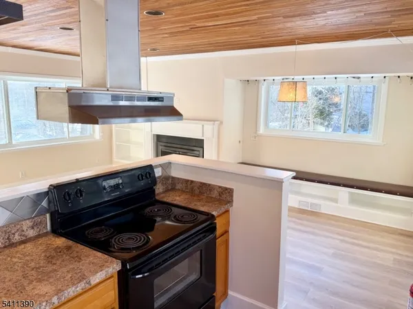 a stove top oven sitting inside of a kitchen