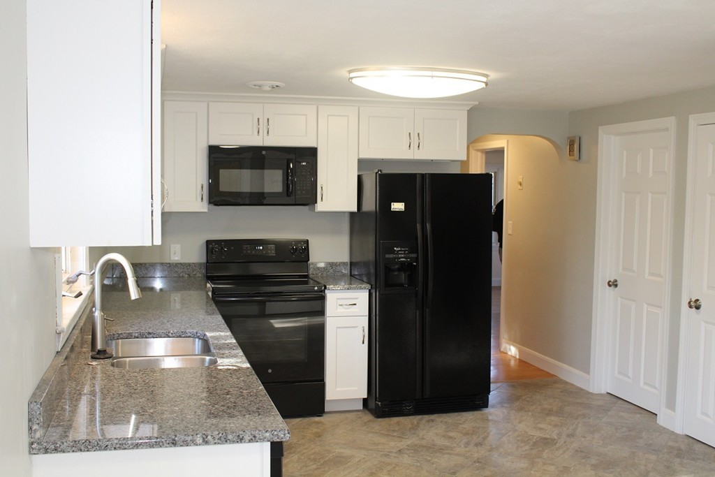 154 Carnavon Circle Springfield, MA 01109 - Photo 5 of 17 a kitchen with stainless steel appliances granite countertop a refrigerator a stove and a sink