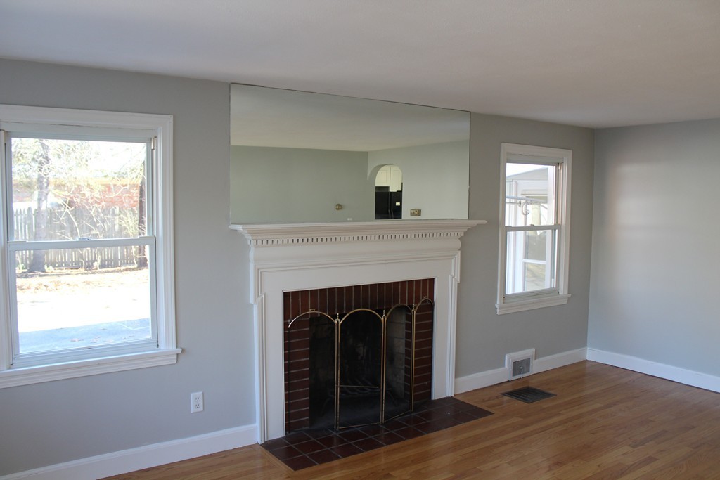 154 Carnavon Circle Springfield, MA 01109 - Photo 7 of 17 a living room with a fireplace and wooden floor
