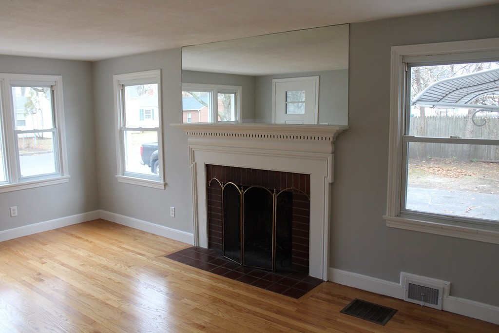 154 Carnavon Circle Springfield, MA 01109 - Photo 8 of 17 a view of an empty room with wooden floor and a window