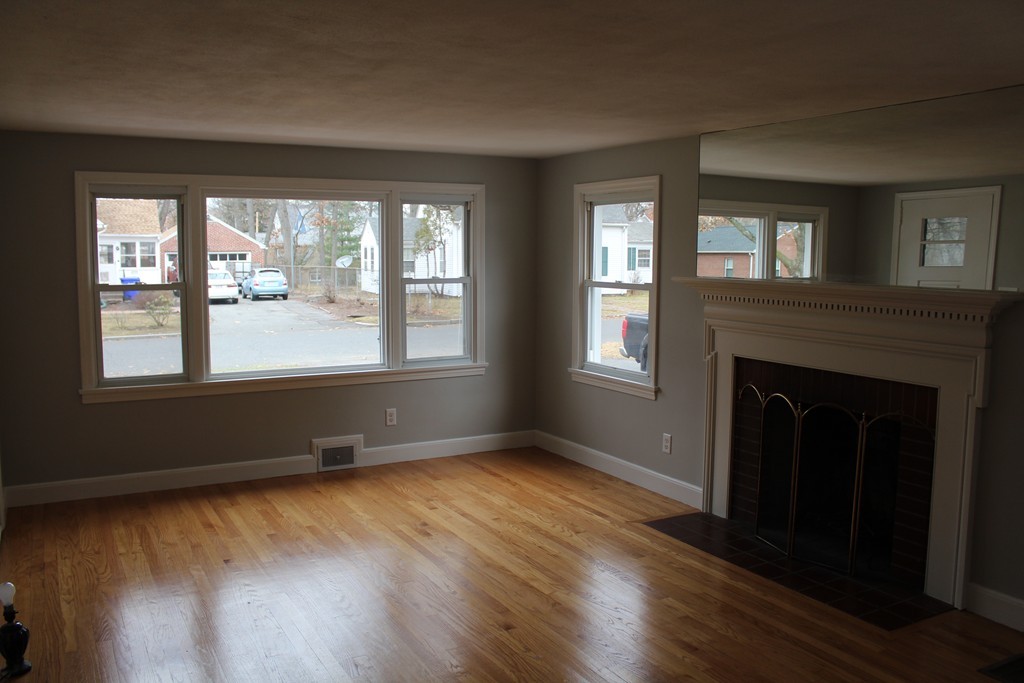 154 Carnavon Circle Springfield, MA 01109 - Photo 10 of 17 a view of an empty room with wooden floor and a window
