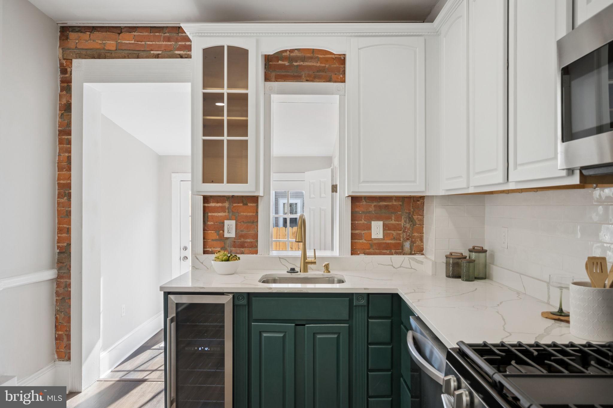1108 South Clinton Street Baltimore, MD 21224 - Photo 14 of 66 Charming kitchen with exposed brick.