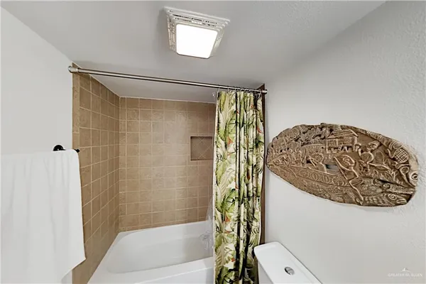 a bathroom with a toilet and shower
