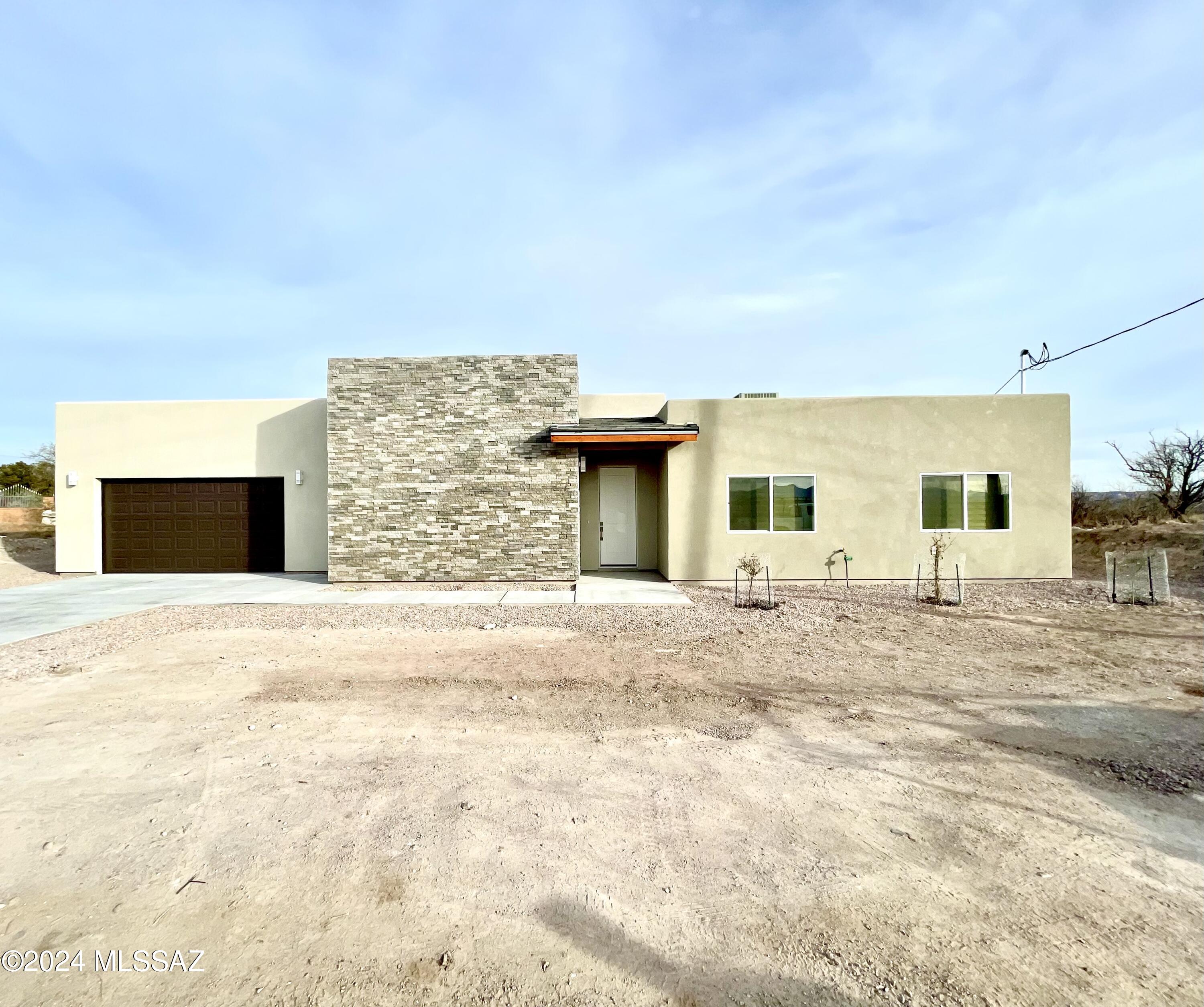 1049 Camino Estrella Rio Rico, AZ 85648 - Photo 2 of 28 front view of a house with a yard