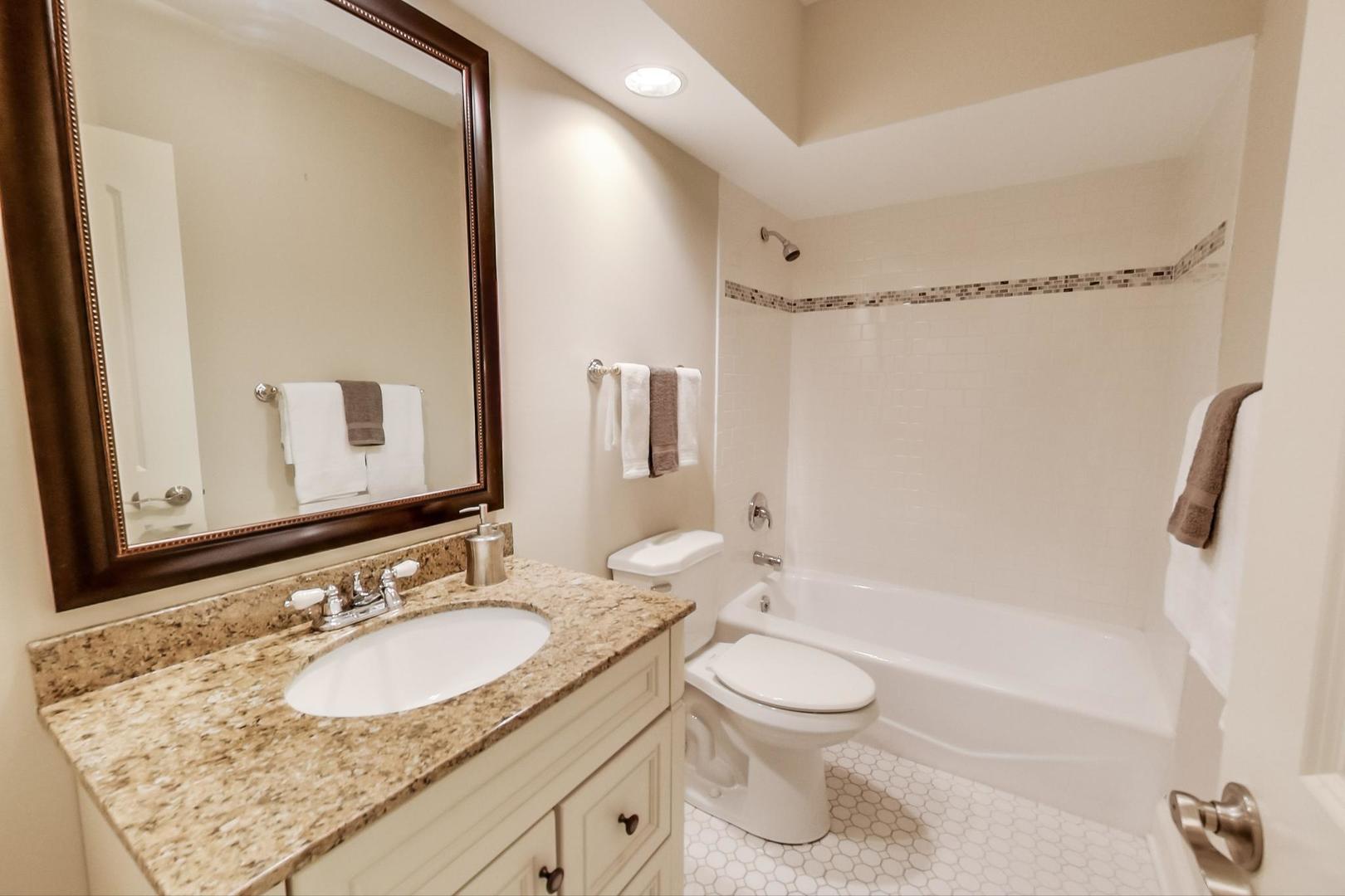 1136 North Greenwood Avenue Park Ridge, IL 60068 - Photo 12 of 30 a bathroom with a granite countertop sink toilet and shower