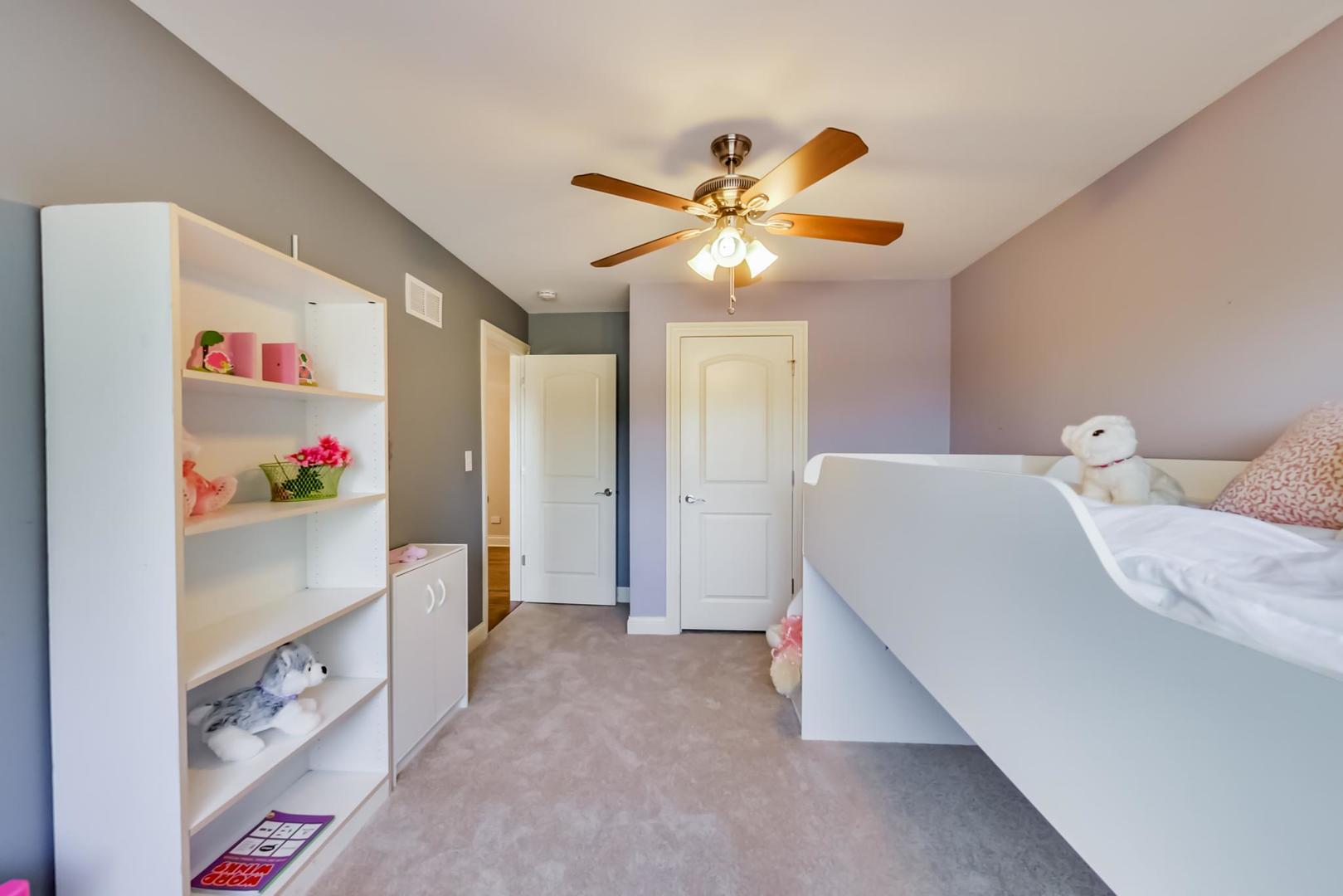 1136 North Greenwood Avenue Park Ridge, IL 60068 - Photo 20 of 30 a bedroom with furniture and a chandelier