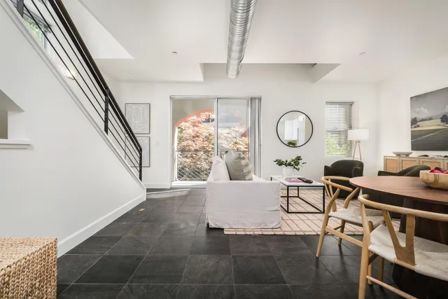 a living room with furniture and a clock