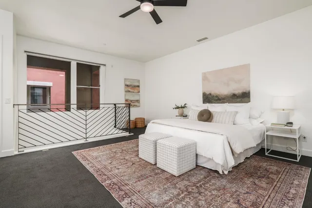 a spacious bedroom with a bed a couch and a dresser